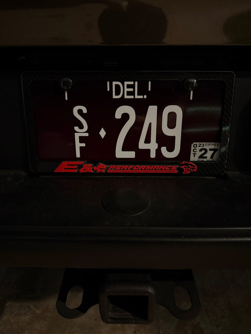 Badge installed on license plate frame